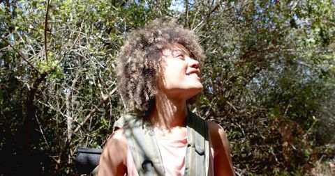 Smiling young woman enjoying outdoor nature adventure