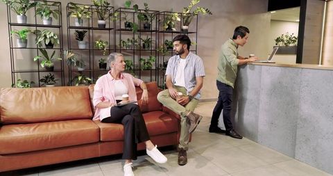 Casual Team Collaboration in Open Office Lounge Area