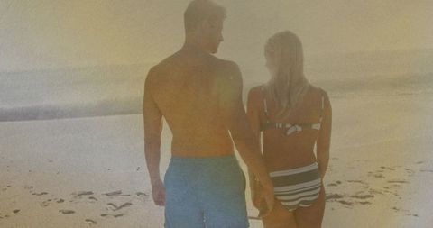 Romantic Walk of Couple at Sunset on Sandy Beach