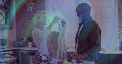 Couple enjoying cooking at home preparing fresh vegetables