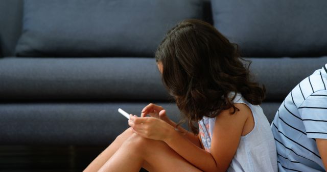 Young Girl Using Smartphone on Living Room Floor - Download Free Stock Images Pikwizard.com