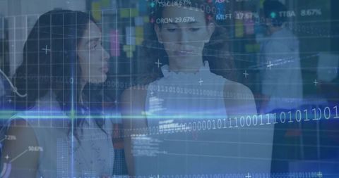 Hispanic women engaged with digital data analytics display