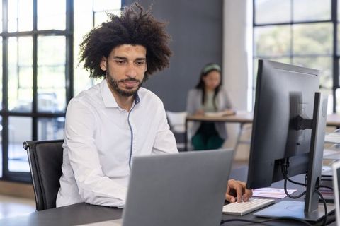 Business Professional Working on Laptop in Modern Office