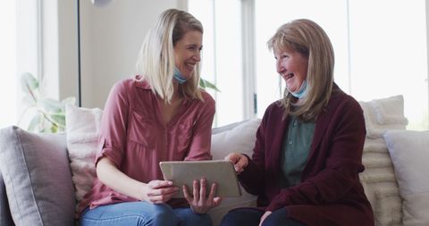 Senior Mother and Daughter Joyful Interaction with Tablet