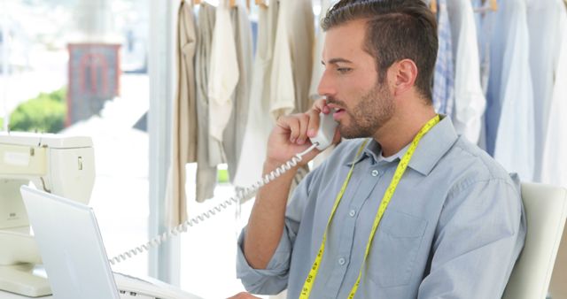 Fashion Designer Working on Laptop While Talking on Phone - Download Free Stock Images Pikwizard.com