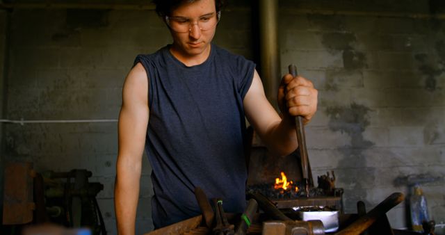 Focused Blacksmith Worker Forging Metal in Workshop - Download Free Stock Images Pikwizard.com