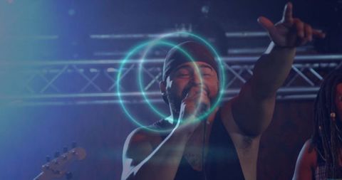 Dynamic Male Vocalist Energizing Audience During Live Concert