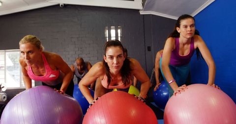 Determined Women Exercising with Stability Balls in Fitness Studio - Download Free Stock Images Pikwizard.com