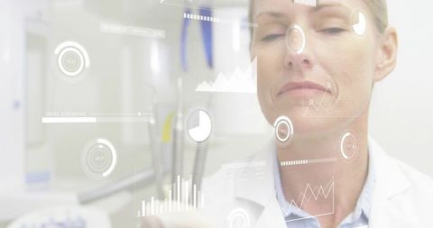 Senior female physician interacting with futuristic hud diagnostics and data visualizations