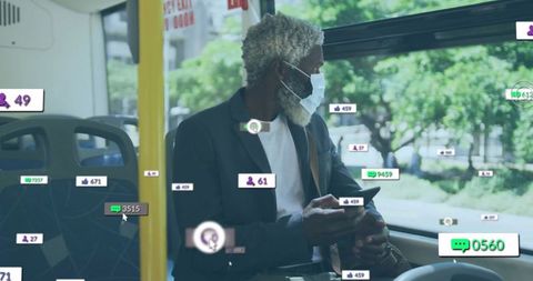 Masked commuter engaged with smartphone on bus with digital icons