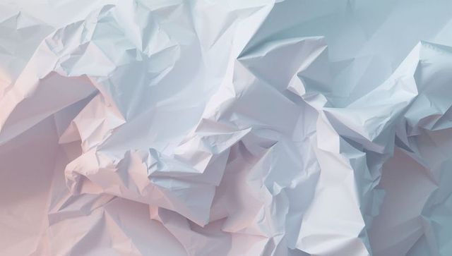 Crumpled white paper texture with pastel illumination for creative background