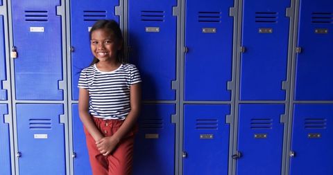 Confident Girl in School Hallway Next to Blue Lockers - Download Free Stock Images Pikwizard.com