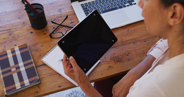 Woman Working at Home with Tablet and Laptop on Wooden Desk - Download Free Stock Images Pikwizard.com