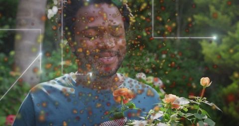Smiling man smelling peach roses with ar overlay in backyard garden, daylight urban gardening