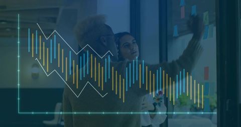 Team brainstorming with digital data visualization in modern office