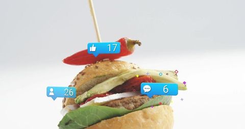Gourmet slider garnished with chili and social media icons driving online food engagement