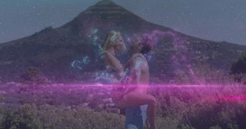 Romantic embrace in ethereal mountain landscape