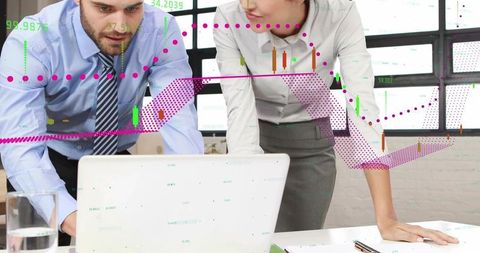 Two professionals analyzing financial data on laptop with magenta trend lines and charts
