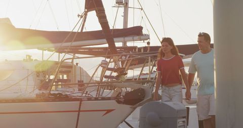 Father and Daughter Walking on Deck at Marina Sunset