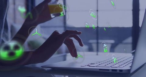 Hands typing on laptop with green holographic sustainability icons, remote work concept