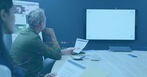 Business meeting analyzing digital code for risk management