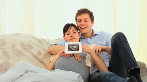 Happy Couple Relaxing with Ultrasound Scan