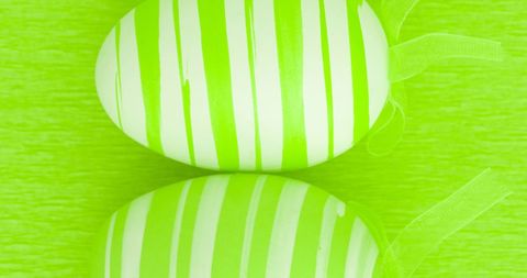 Striped Easter Eggs on Vibrant Green Background - Download Free Stock Images Pikwizard.com