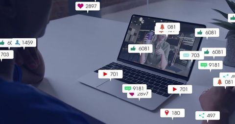 Laptop livestream host engaging audience with real-time social metrics, likes and comments