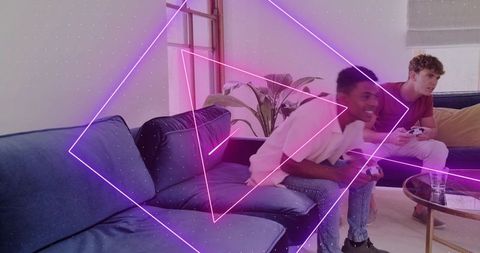 Friends playing console games on blue sectional sofa with neon geometric overlay, home gaming
