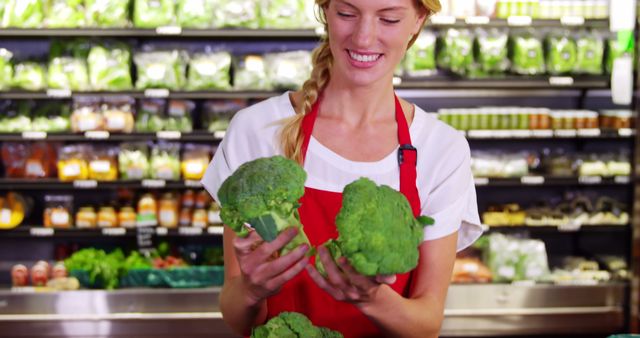 Smiling Female Grocery Worker Sorting Fresh Broccoli in Store - Download Free Stock Images Pikwizard.com