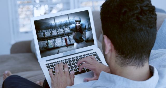 Man Watching Virtual Reality Sports Game on Laptop at Home - Download Free Stock Images Pikwizard.com