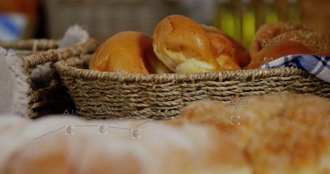 Artisanal bread rolls in wicker baskets at rustic market stall