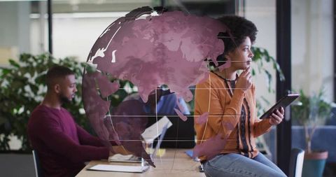 Woman with Tablet Reflecting on Global Connectivity in Office
