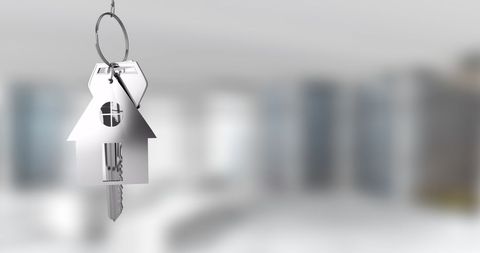 House-shaped Keychain with Blurred Modern Interior Background