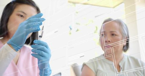 Nurse preparing vaccine syringe with gloved hands while patient watches in bright clinic
