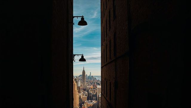 Narrow rooftop alley framing manhattan skyline with empire state building and one wtc
