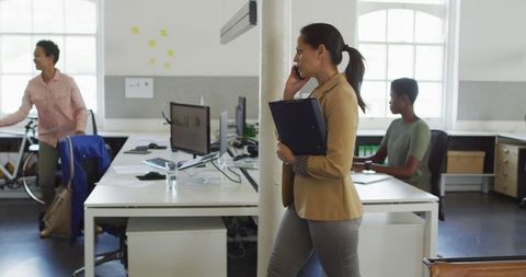 Businesswoman Talking on Smartphone in Modern Office Environment