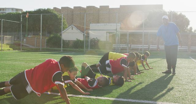 Young Soccer Team Training Outdoors with Coach - Download Free Stock Images Pikwizard.com