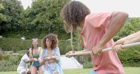 Friends Enjoying Tug-of-War Game in Outdoor Lifestyle Setting