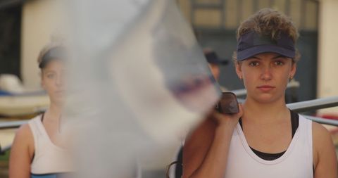 Focused rowing athlete preparing for competition outdoors