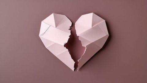 Origami Paper Heart Broken in Two on Mauve Background