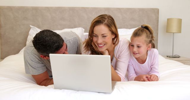 Happy Family Watching Laptop in Bedroom - Download Free Stock Images Pikwizard.com