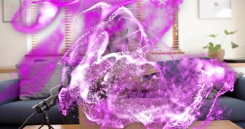 Man recording podcast on sofa with microphone and laptop, purple visual overlay