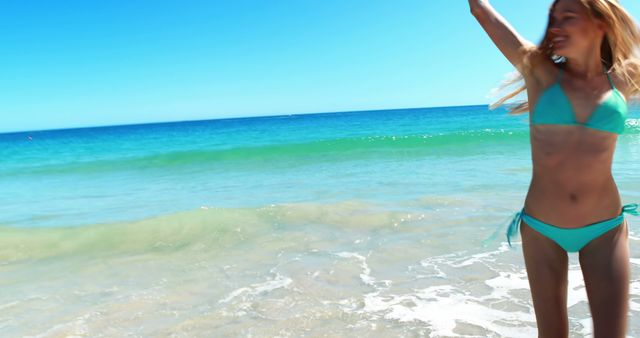 Excited woman dancing on beach on a sunny day 4k
