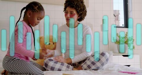 Mother and daughter bonding on bed with teddy bear, cozy plaid pajamas and calm moment