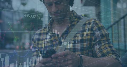 Man Using Smartphone with Financial Data Overlay in Urban Setting