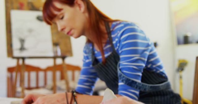 Young Female Artist Concentrating on Painting in Studio - Download Free Stock Images Pikwizard.com