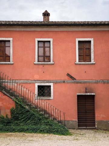 Rustic Pink Tuscan Facade with Ivy-Covered Staircase, Wooden Shutters and Brick Chimney