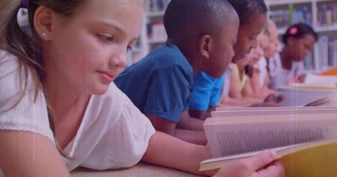 Children Lying in Library Reading Books Together, Fostering Literacy, Focus and Teamwork
