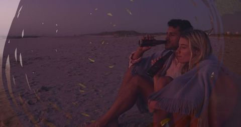 Caucasian Couple Enjoying Beach Sunset with Beverages
